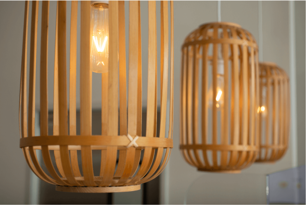 Image of 3 boho pendant lights with natural wood surrounding the bulb.